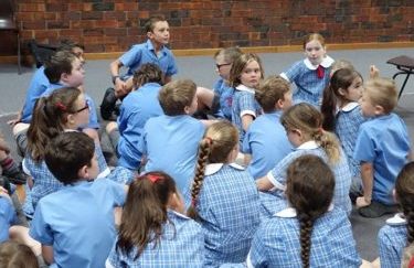 Teacher talking to group of children