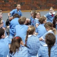 Teacher talking to group of children